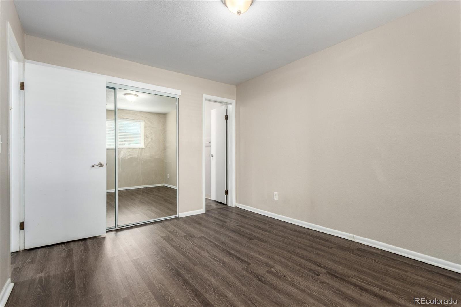 16359 West 10th Avenue, Unit O Golden, CO 80401 - Photo 23 of 25 a view of an empty room with wooden floor