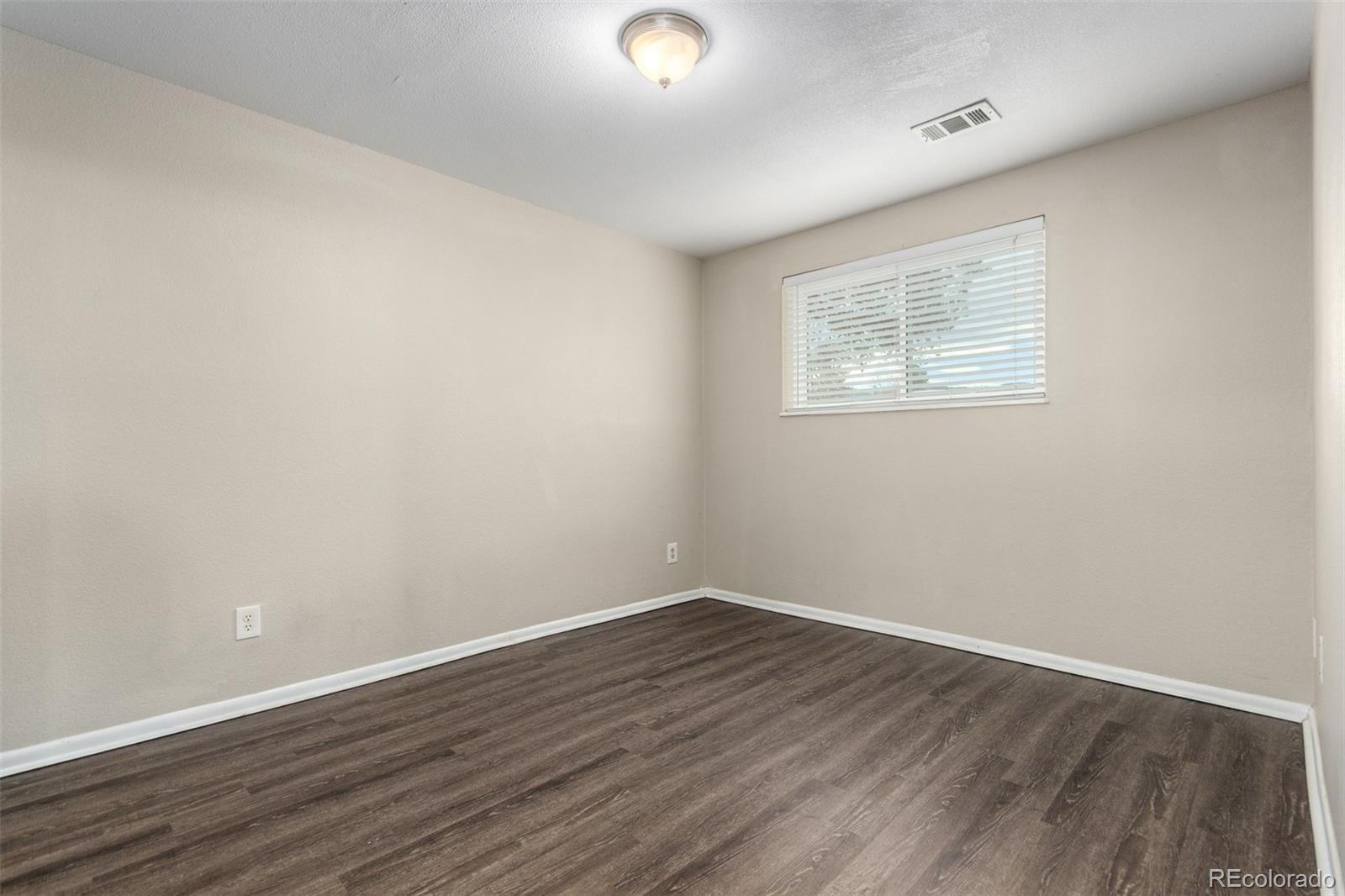 16359 West 10th Avenue, Unit O Golden, CO 80401 - Photo 24 of 25 an empty room with wooden floor and windows