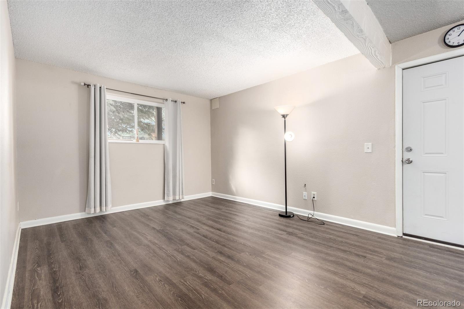 16359 West 10th Avenue, Unit O Golden, CO 80401 - Photo 5 of 25 an empty room with wooden floor and windows