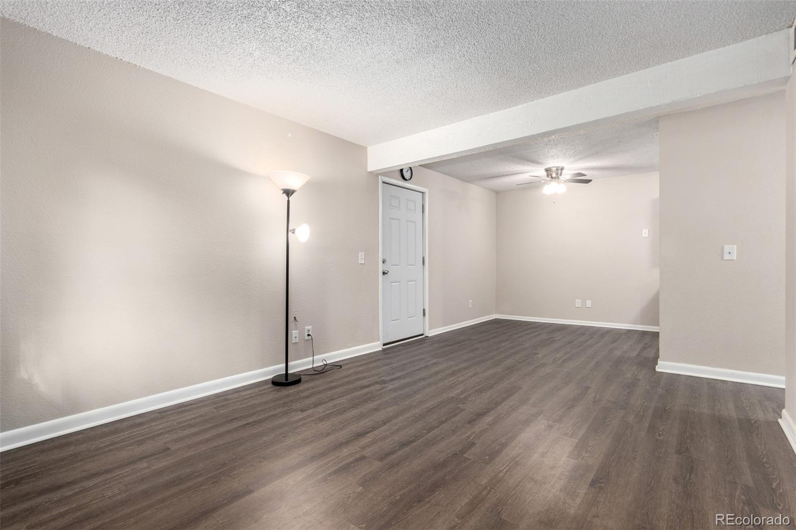 16359 West 10th Avenue, Unit O Golden, CO 80401 - Photo 6 of 25 an empty room with wooden floor and mirror
