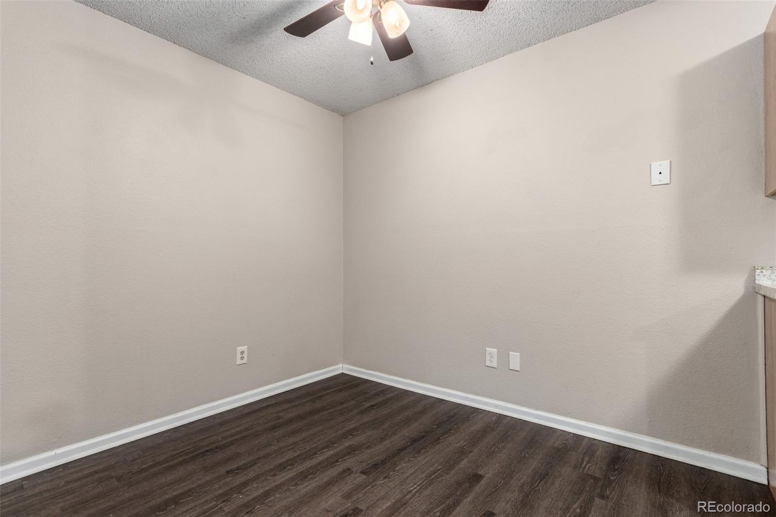 16359 West 10th Avenue, Unit O Golden, CO 80401 - Photo 10 of 25 a view of an empty room with wooden floor