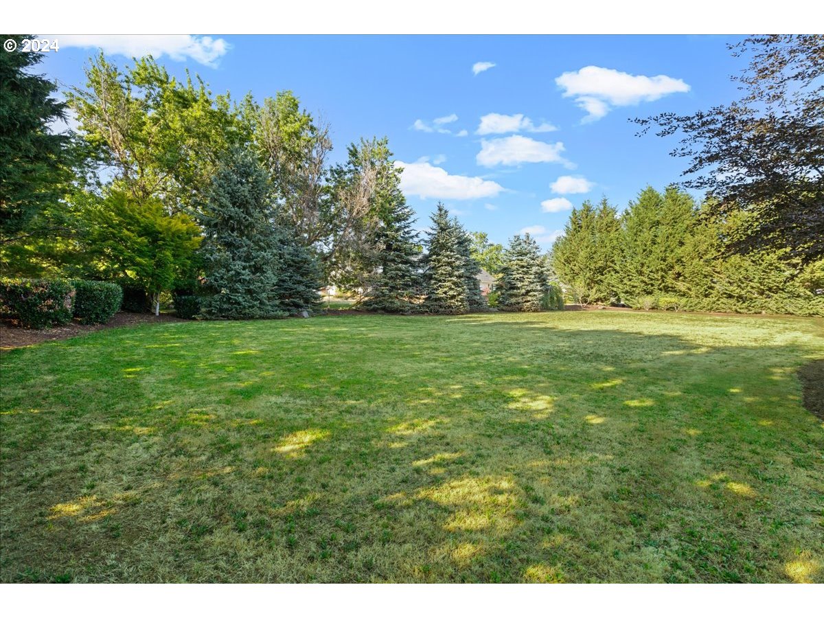 9400 Southwest Inverness Way Beaverton, OR 97007 - Photo 44 of 48 a view of a green field with trees in the background