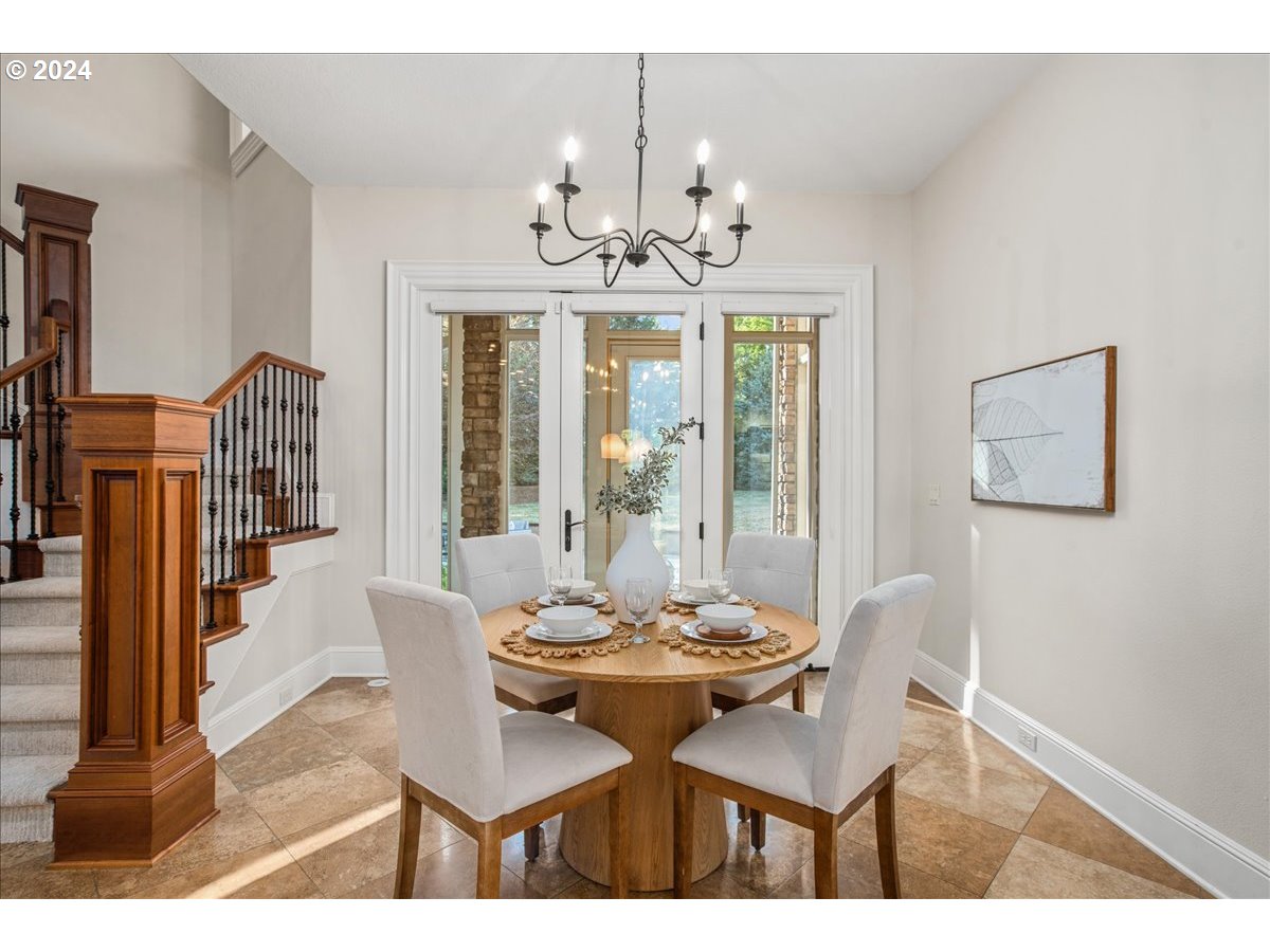 9400 Southwest Inverness Way Beaverton, OR 97007 - Photo 10 of 48 a view of a dining room with furniture a chandelier and wooden floor