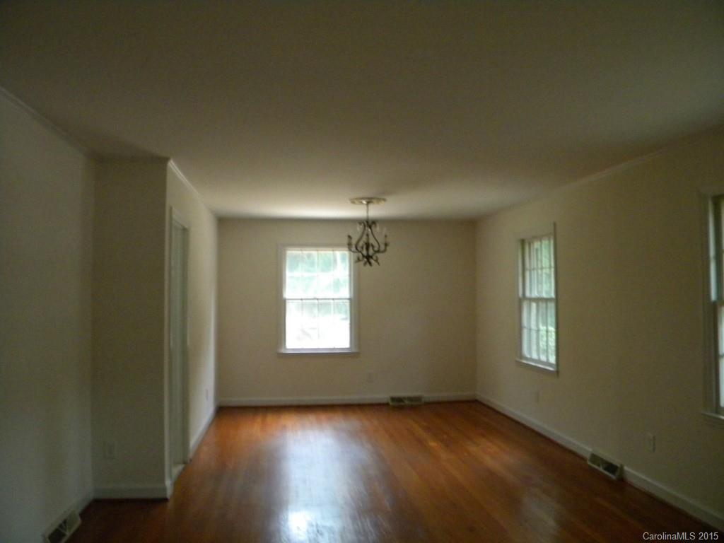 305 Pine Road Davidson, NC 28036 - Photo 4 of 9 an empty room with wooden floor and windows