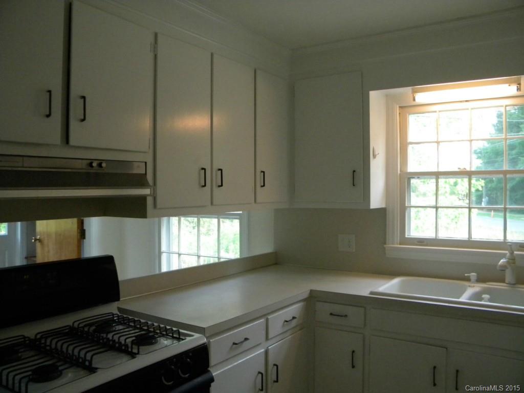 305 Pine Road Davidson, NC 28036 - Photo 6 of 9 a kitchen with a sink cabinets and window