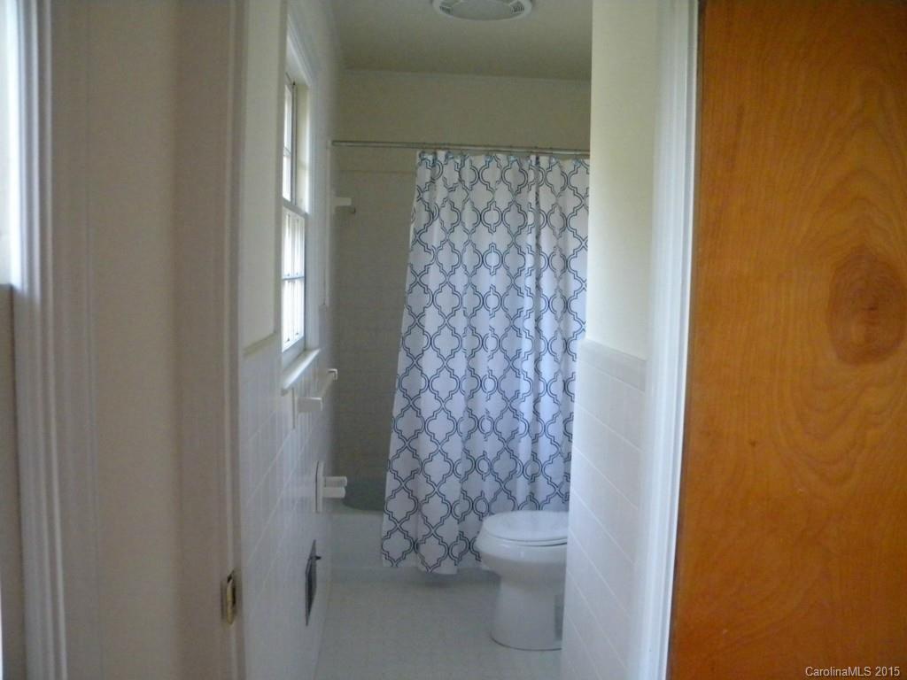 305 Pine Road Davidson, NC 28036 - Photo 8 of 9 a bathroom with a toilet and a shower curtain