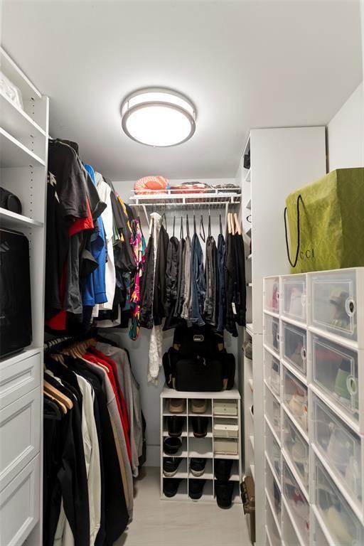 3100 Northeast 48th Court, Unit 413 Lighthouse Point, FL 33064 - Photo 13 of 32 a view of walk in closet with clothes and shoes
