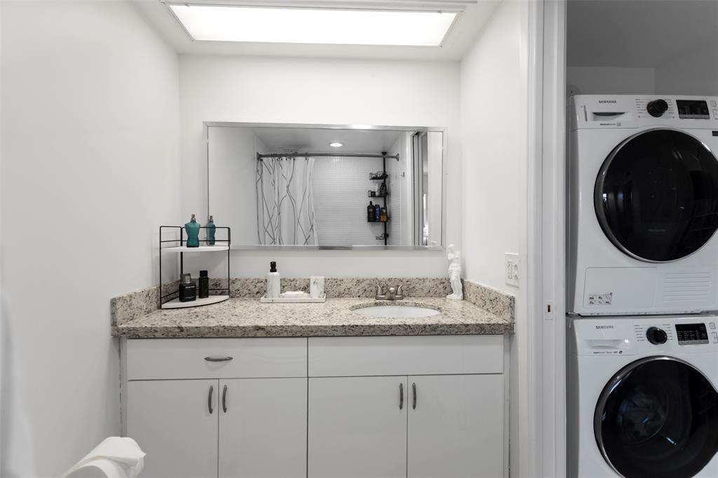 3100 Northeast 48th Court, Unit 413 Lighthouse Point, FL 33064 - Photo 14 of 32 a bathroom with a sink and a mirror