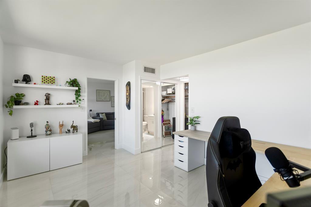 3100 Northeast 48th Court, Unit 413 Lighthouse Point, FL 33064 - Photo 16 of 32 a living room with furniture and a painting on the wall