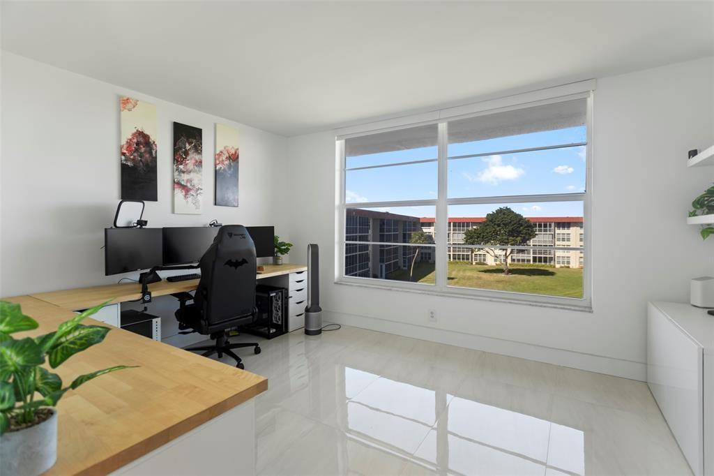 3100 Northeast 48th Court, Unit 413 Lighthouse Point, FL 33064 - Photo 17 of 32 a view of a workspace with furniture and a window