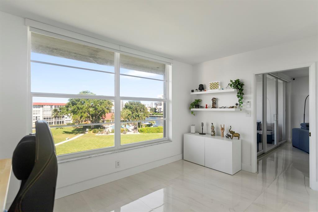 3100 Northeast 48th Court, Unit 413 Lighthouse Point, FL 33064 - Photo 18 of 32 a bathroom with a bathtub and a window