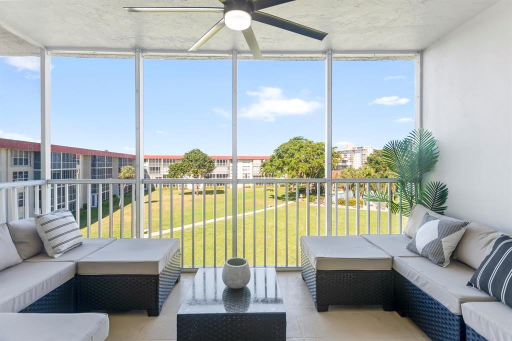 3100 Northeast 48th Court, Unit 413 Lighthouse Point, FL 33064 - Photo 22 of 32 a living room with furniture and a floor to ceiling window