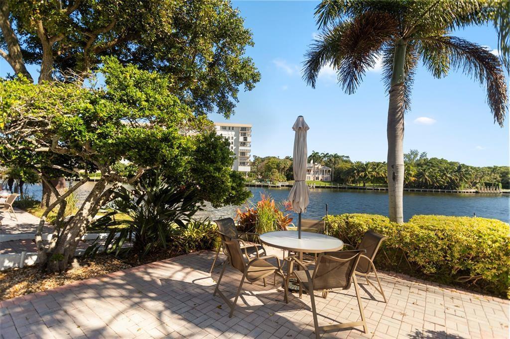 3100 Northeast 48th Court, Unit 413 Lighthouse Point, FL 33064 - Photo 25 of 32 a lake view with a table and chairs