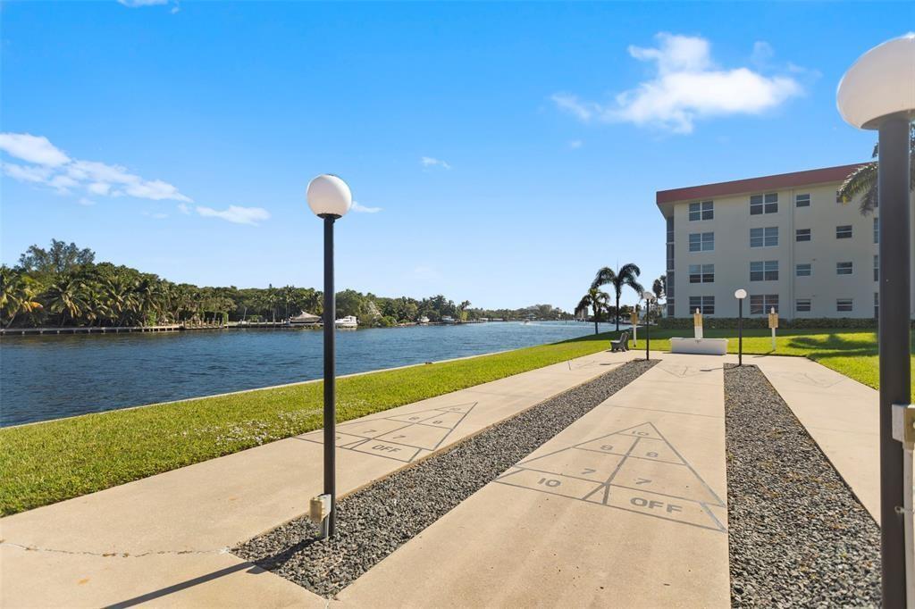 3100 Northeast 48th Court, Unit 413 Lighthouse Point, FL 33064 - Photo 27 of 32 a view of a swimming pool with a lake view