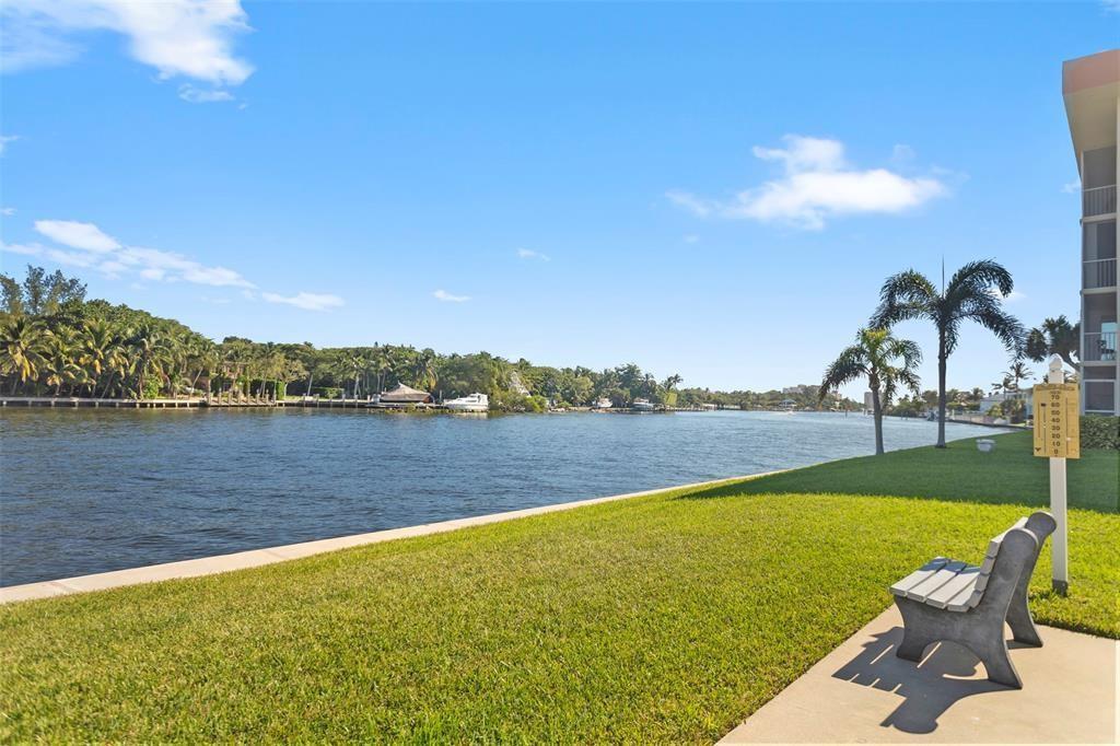 3100 Northeast 48th Court, Unit 413 Lighthouse Point, FL 33064 - Photo 28 of 32 a view of a lake with a table and chairs