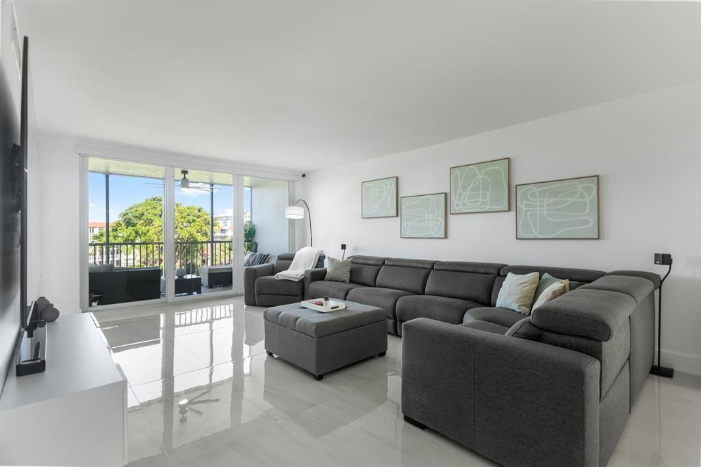 3100 Northeast 48th Court, Unit 413 Lighthouse Point, FL 33064 - Photo 4 of 32 a living room with furniture and a potted plant