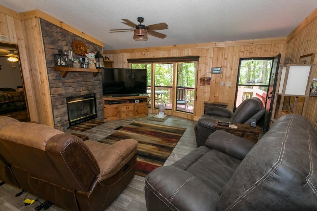 3260 Duncan Springs Road Seymour, TN 37865 - Photo 3 of 32 a living room with furniture a flat screen tv and a fireplace