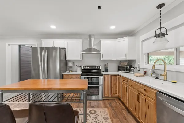 a kitchen with stainless steel appliances granite countertop a sink stove and refrigerator