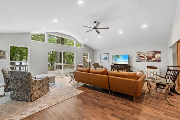 a living room with furniture a large window and a rug