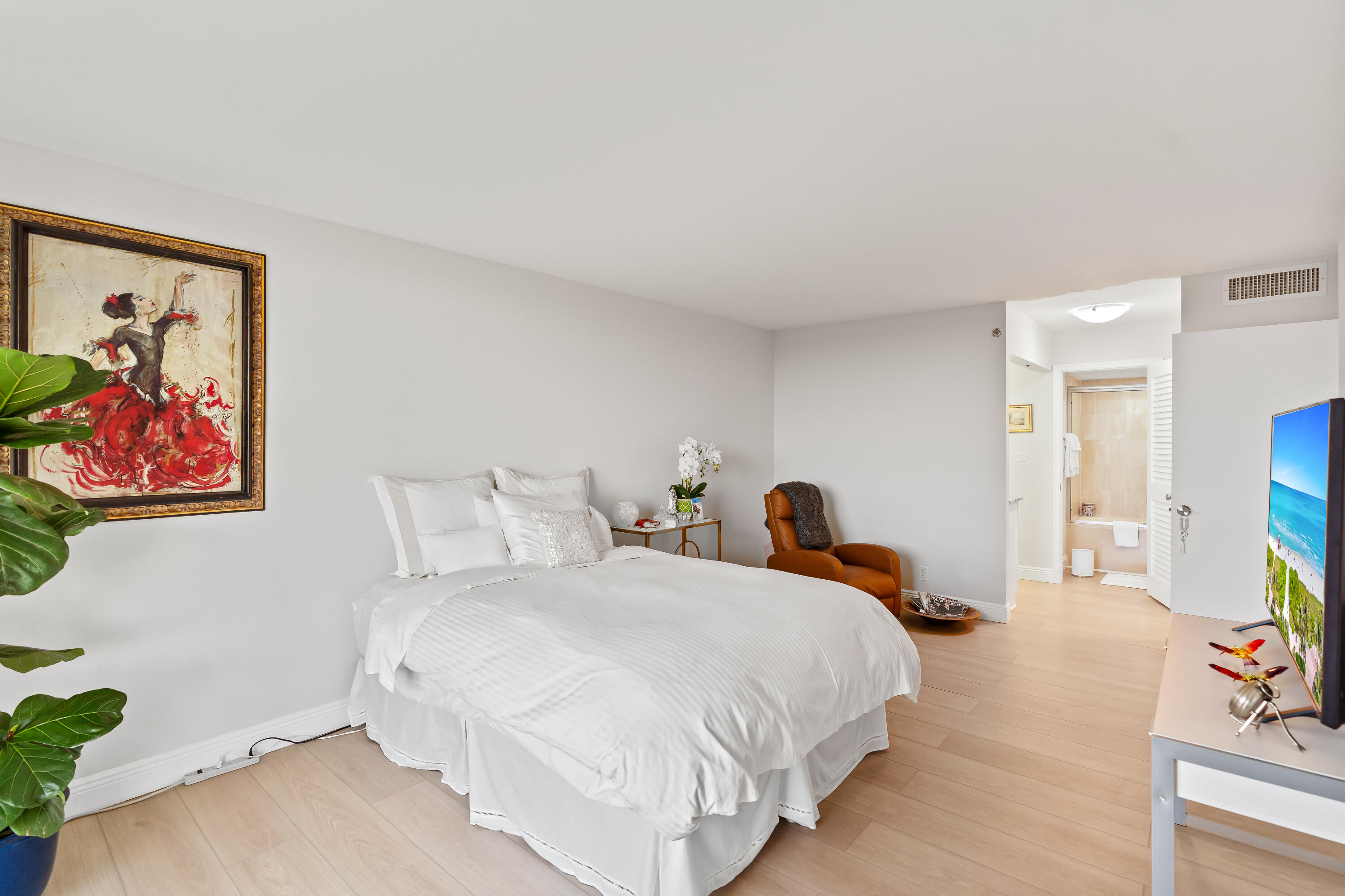 23200 Camino Del Mar, Unit 603 Boca Raton, FL 33433 - Photo 18 of 43 a bedroom with a bed and a painting on the wall