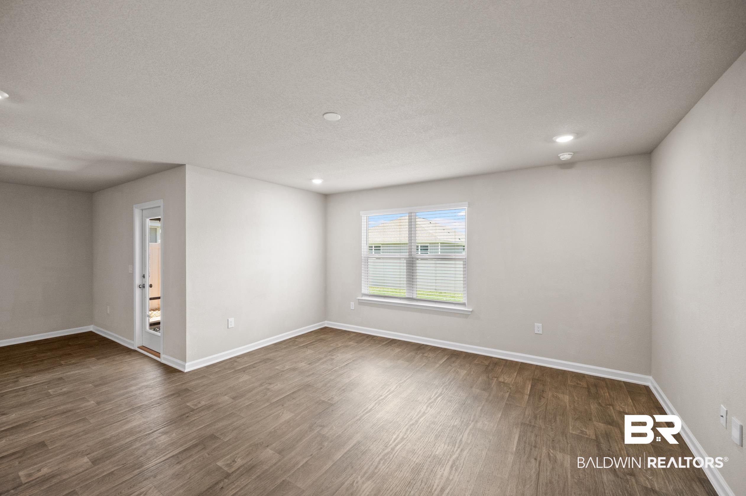 10353 Zenyatta Loop Daphne, AL 36526 - Photo 11 of 33 Spare room with a textured ceiling and wood-type flooring