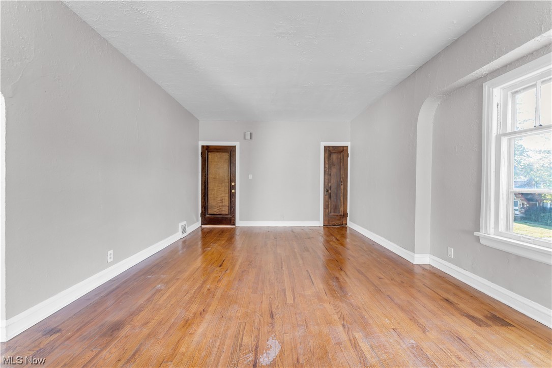 1499 Sherbrook Road South Euclid, OH 44121 - Photo 9 of 41 Hardwood floored empty room with plenty of natural light