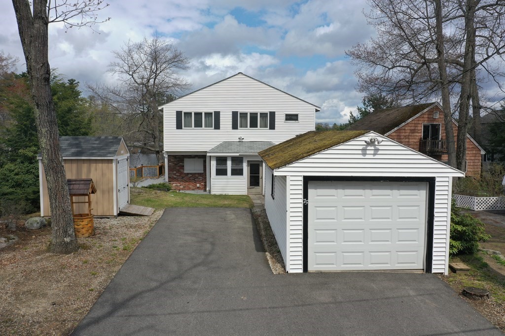 75 Conleys Grove Road Derry, NH 03038 - Photo 11 of 41 a front view of a house with a yard and garage