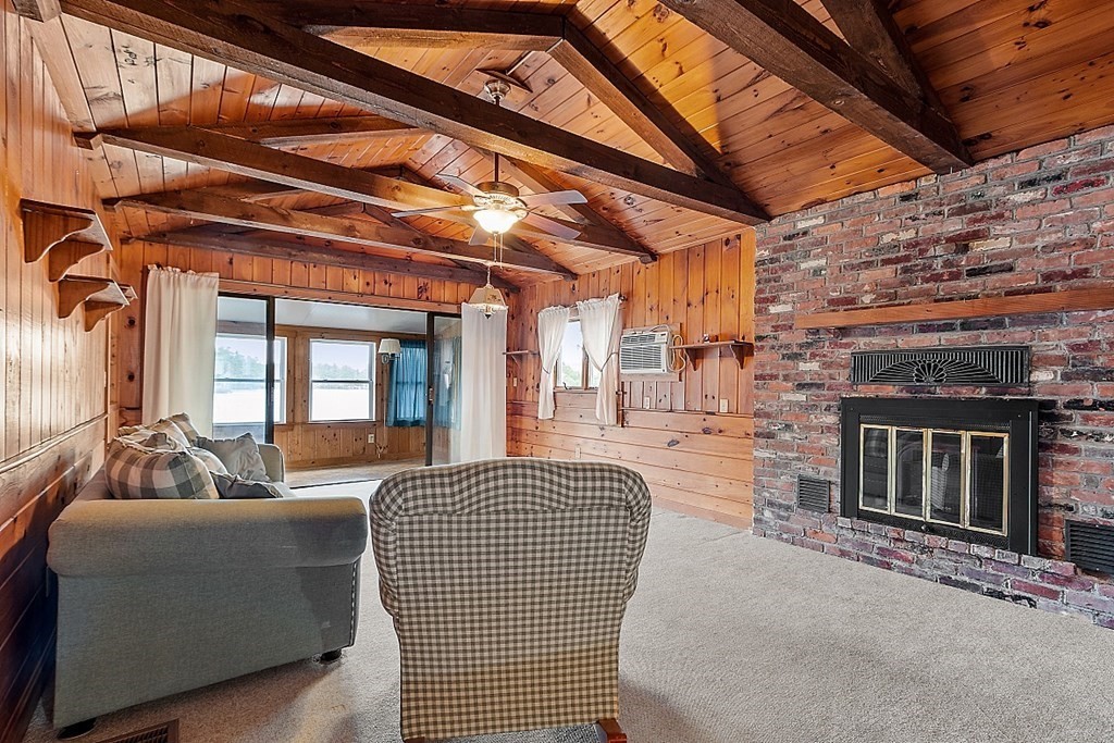 75 Conleys Grove Road Derry, NH 03038 - Photo 14 of 41 a living room with furniture a fireplace and a ceiling fan