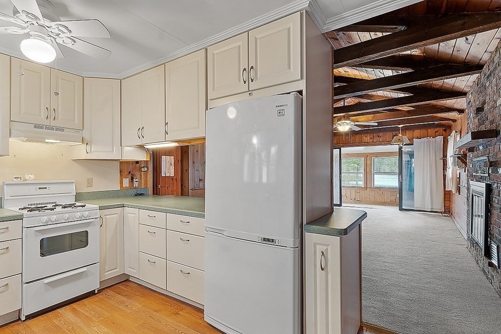 75 Conleys Grove Road Derry, NH 03038 - Photo 22 of 41 a kitchen with white cabinets and white appliances