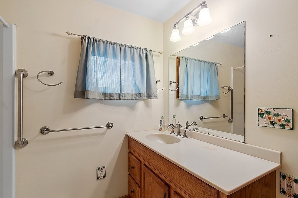 75 Conleys Grove Road Derry, NH 03038 - Photo 27 of 41 a bathroom with a sink vanity granite and a mirror