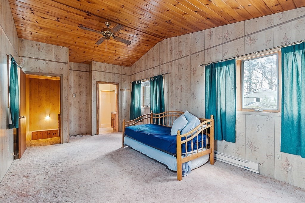 75 Conleys Grove Road Derry, NH 03038 - Photo 30 of 41 a room with a bed and a chandelier