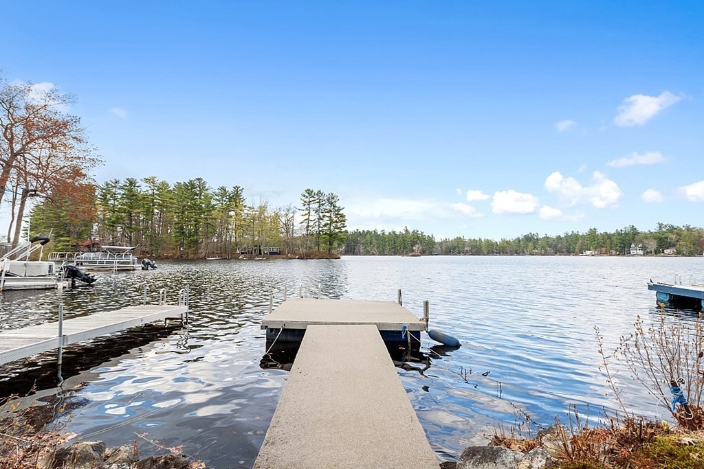 75 Conleys Grove Road Derry, NH 03038 - Photo 3 of 41 a view of a lake with boats and trees in the background