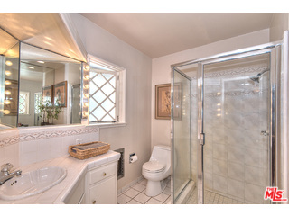 2139 Roscomare Road Los Angeles, CA 90077 - Photo 11 of 21 a bathroom with a granite countertop sink mirror vanity and toilet