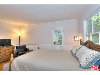2139 Roscomare Road Los Angeles, CA 90077 - Photo 13 of 21 a bedroom with a bed and a flat screen tv