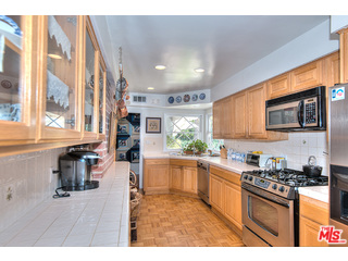 2139 Roscomare Road Los Angeles, CA 90077 - Photo 7 of 21 a kitchen with stainless steel appliances granite countertop a stove a sink and a microwave