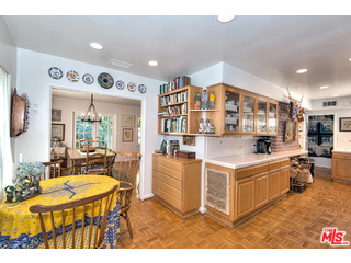 2139 Roscomare Road Los Angeles, CA 90077 - Photo 8 of 21 a living room with stainless steel appliances kitchen island granite countertop a table chairs and a refrigerator