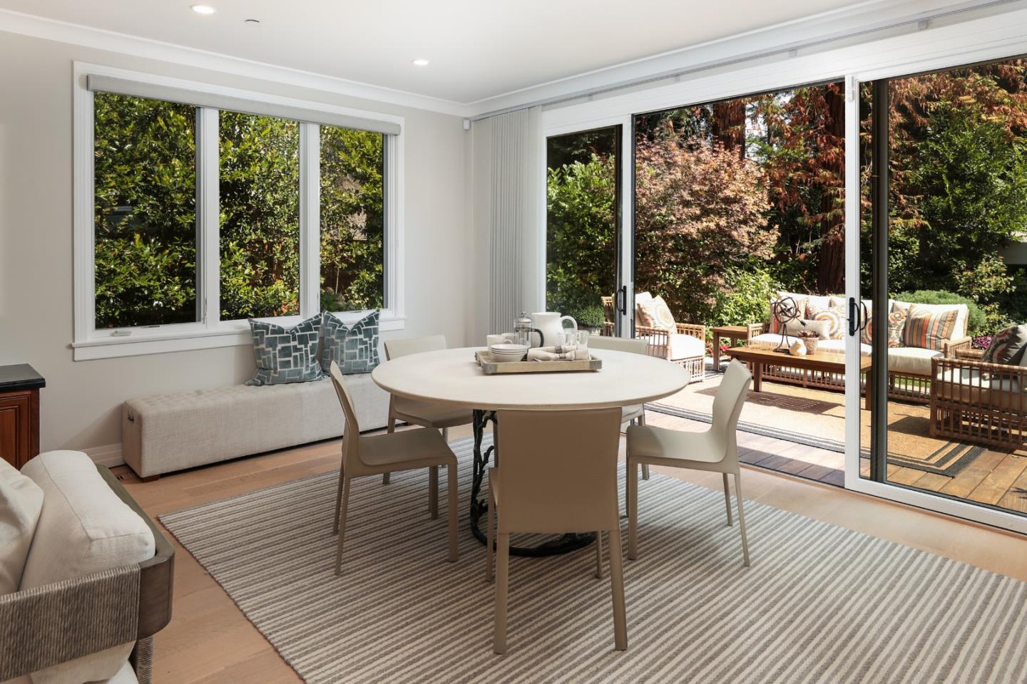 9 Park Drive Atherton, CA 94027 - Photo 10 of 56 a dining room with wooden floor a glass table and chairs