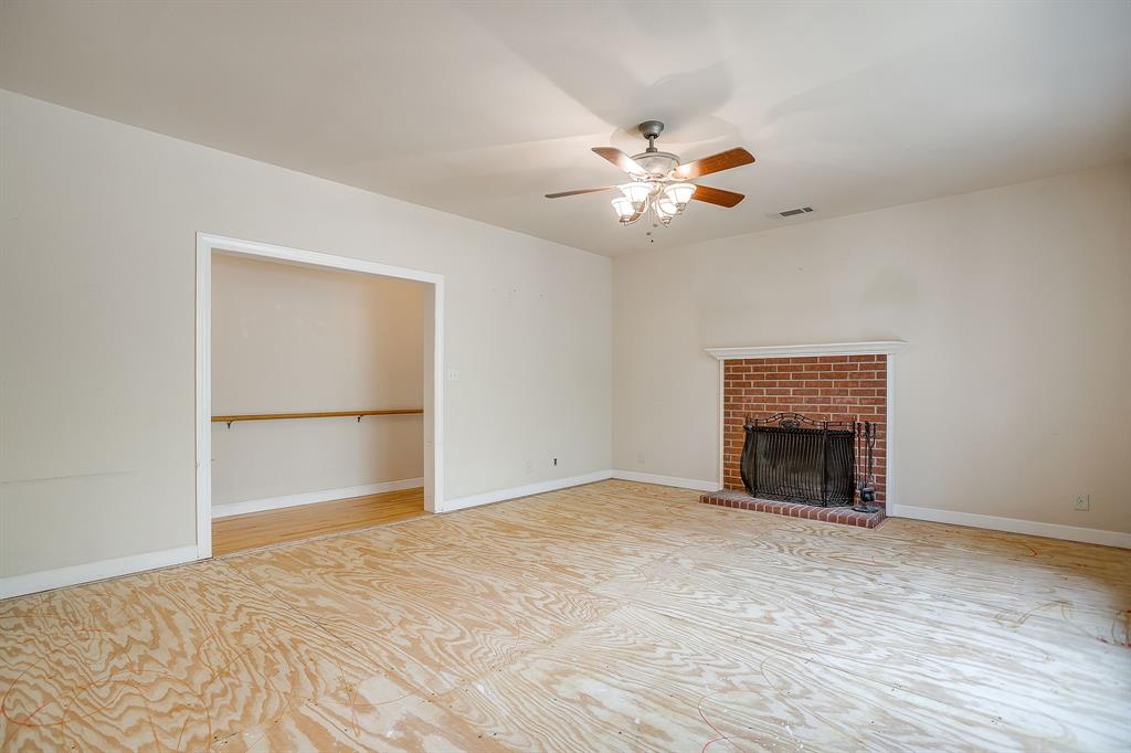 3500 Henderson Ranch Road Bridgeport, TX 76426 - Photo 7 of 40 a view of an empty room with chandelier fan and a fireplace