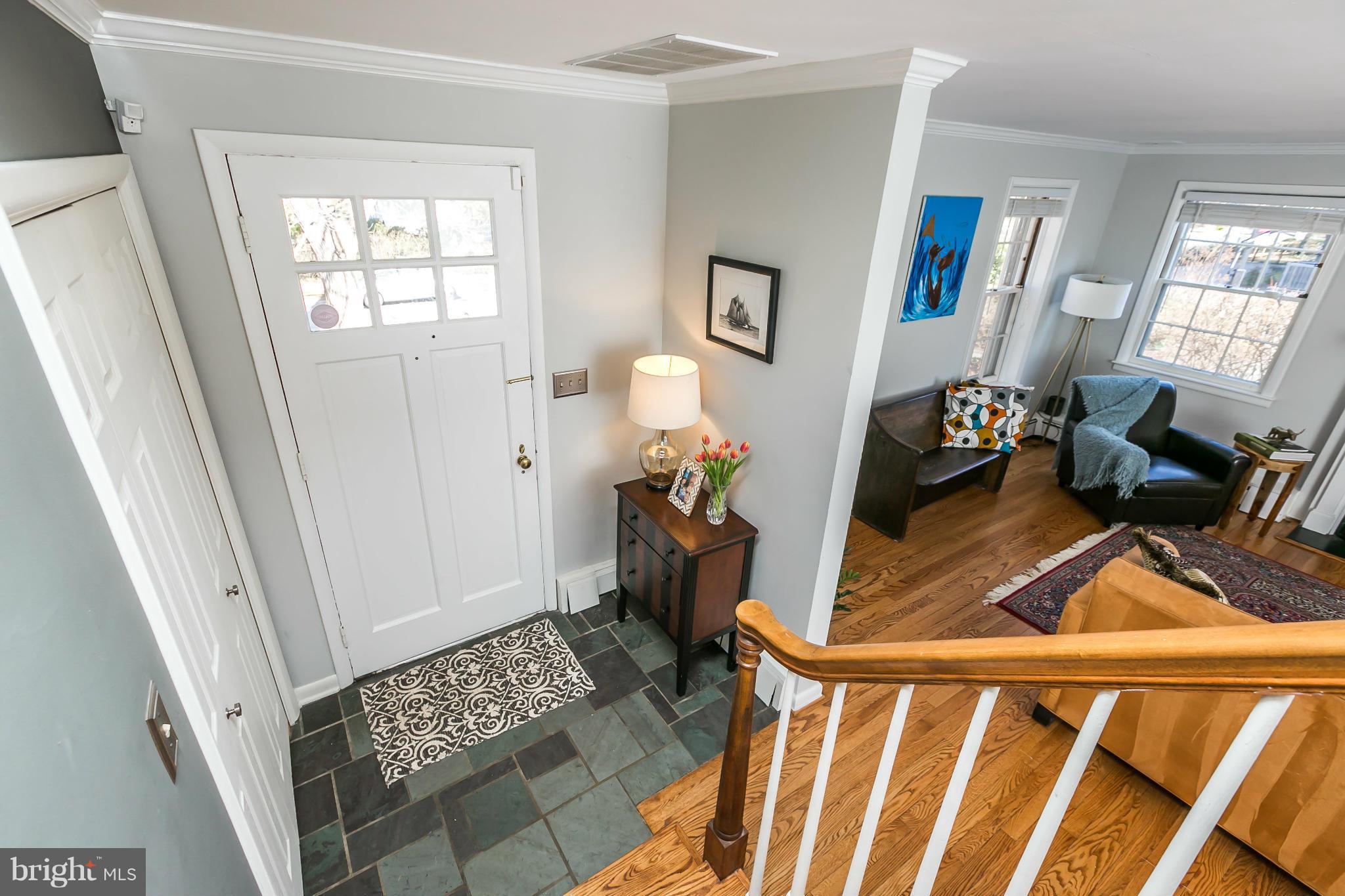 1 Beechdale Road Baltimore, MD 21210 - Photo 3 of 28 a view of a livingroom with wooden floor and a fireplace