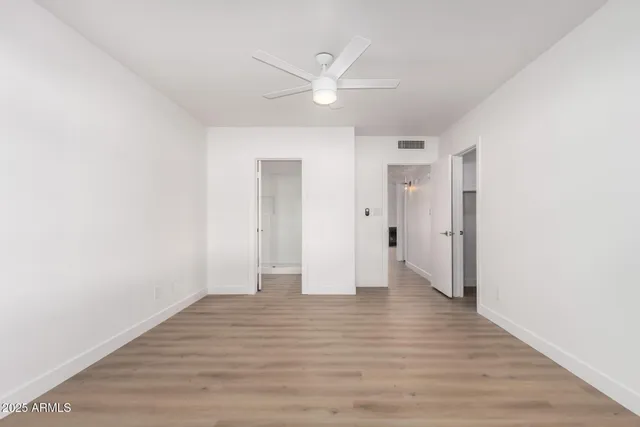 a view of an empty room with wooden floor