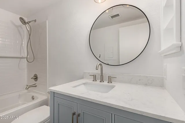 a bathroom with a sink a toilet and a mirror