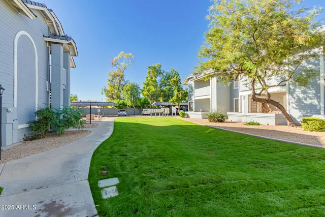a view of a house with a backyard