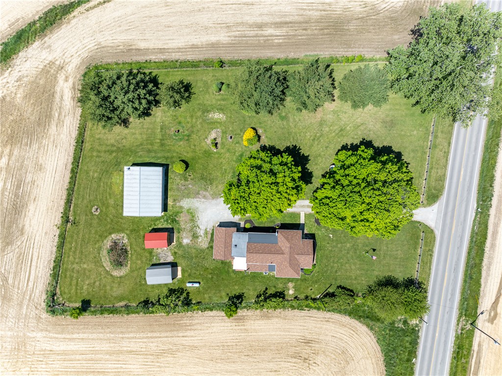 1217 Jasper Road Xenia, OH 45385 - Photo 16 of 62 An aerial view showcases a residential property surrounded by expansive agricultural fields.
