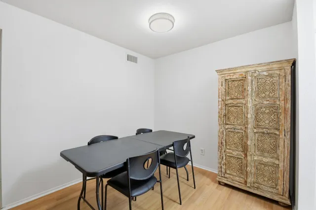 a view of a workspace with furniture and wooden floor