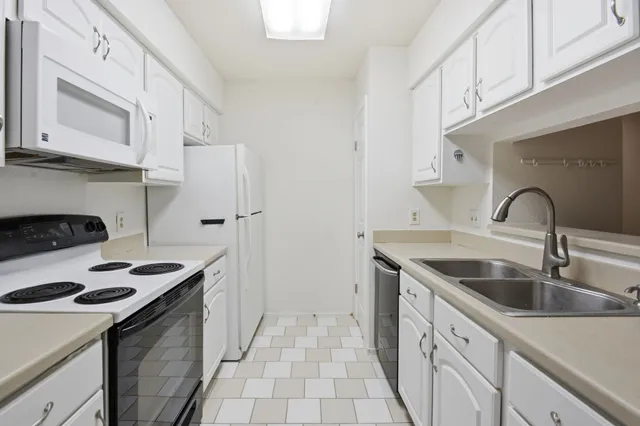 a kitchen with white cabinets