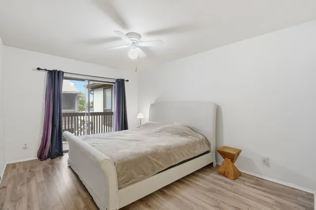 a spacious bedroom with a bed and a chandelier