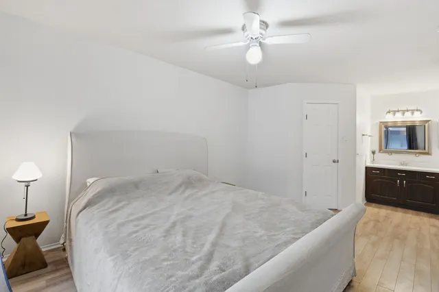 a view of a big room with chandelier fan and windows