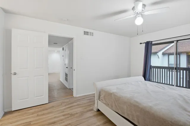 a bedroom with a bed and a ceiling fan