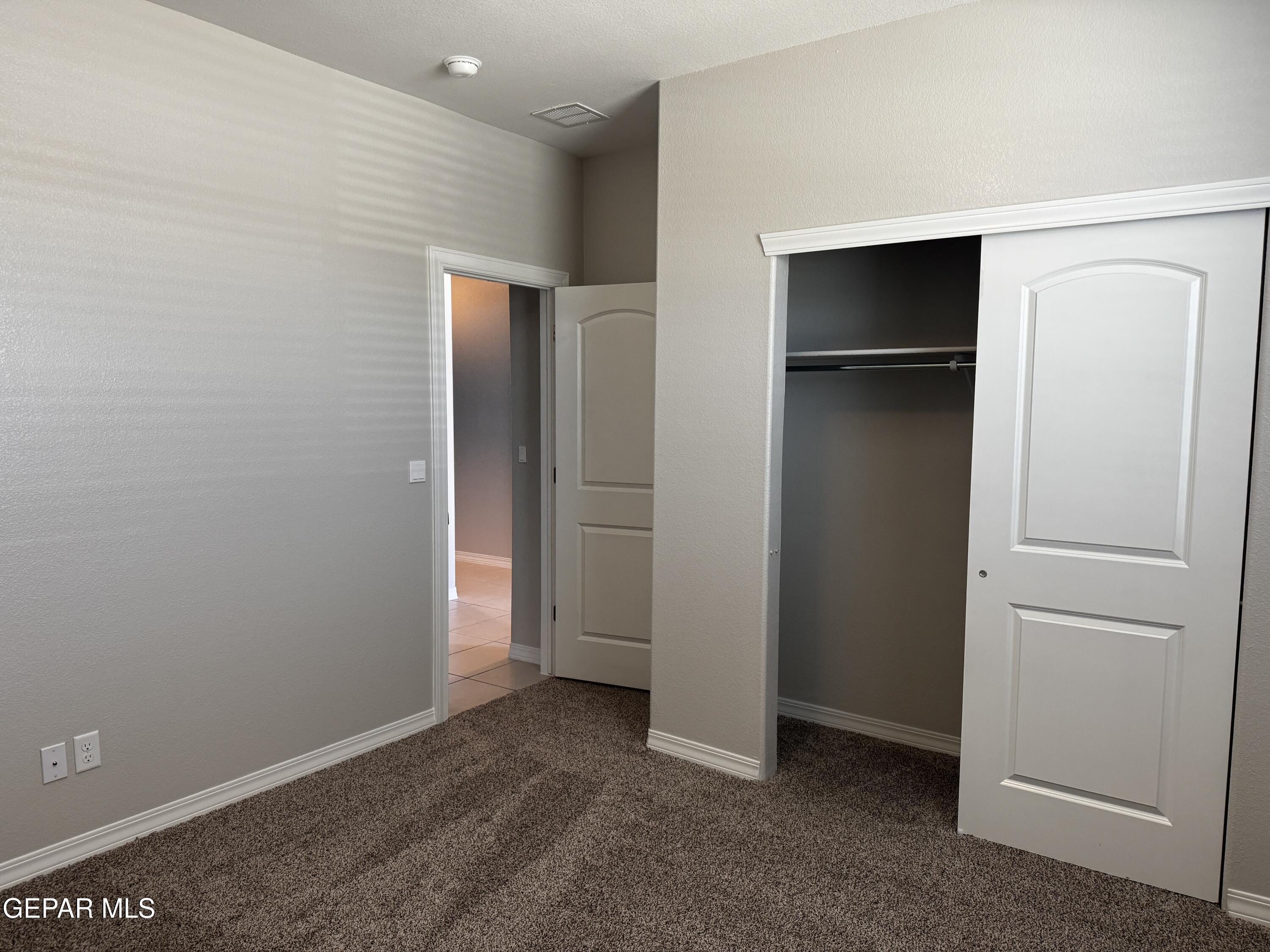 14434 Aria Lopez Drive El Paso, TX 79938 - Photo 11 of 37 a view of an empty room with closet and wooden floor