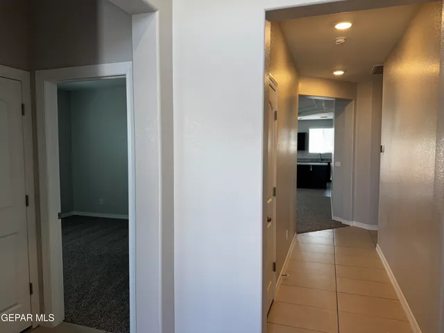 a view of hallway with a bathroom and a bathroom
